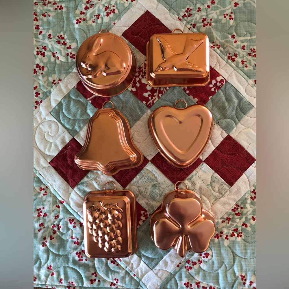 Set of 6 copper colored molds.